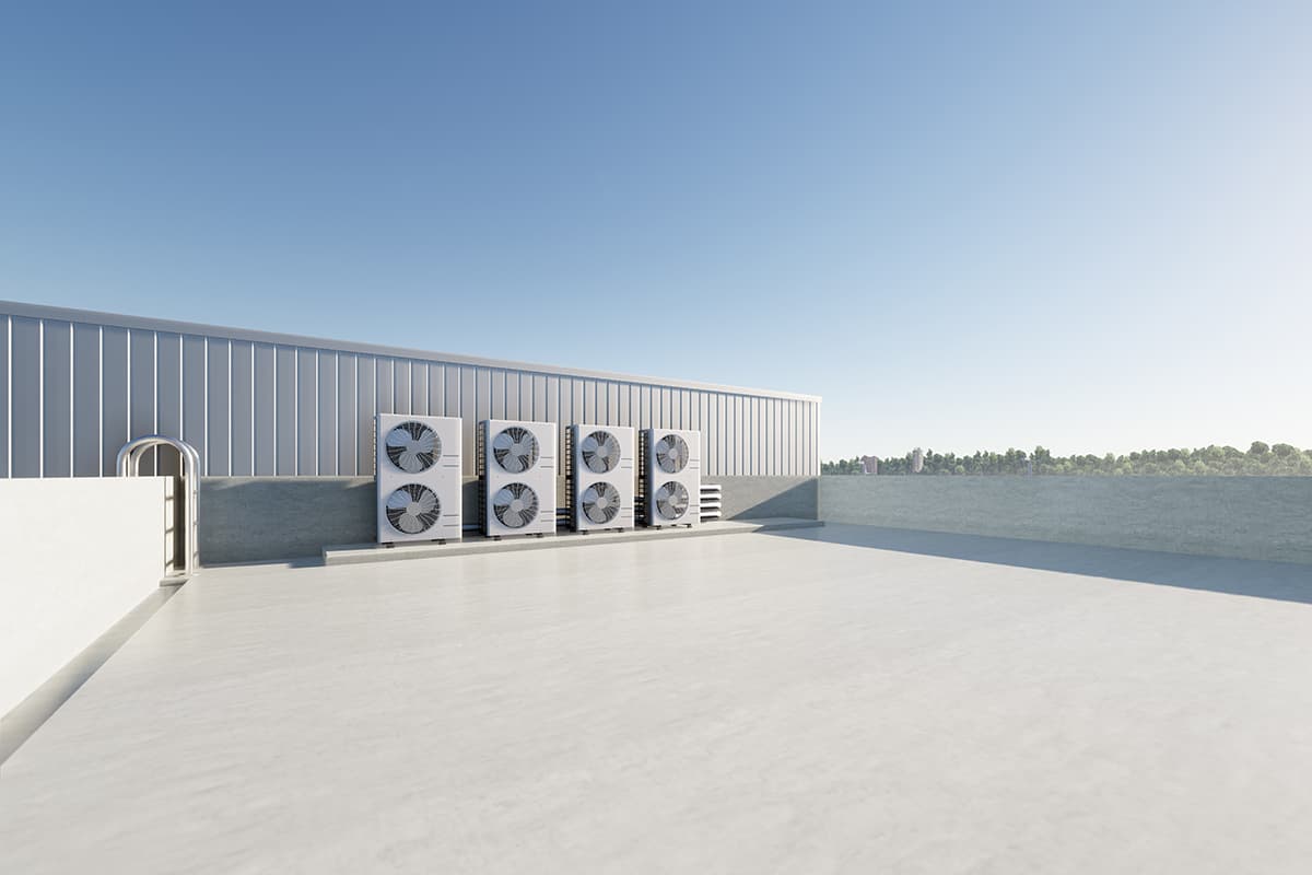 AC condenser unit or compressor on rooftop of industrial plant.